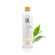 Bottle of GK Hair Anti-Dandruff Shampoo with a bright orange cap, featuring green tea leaves beside it, promoting hair health and hydration.