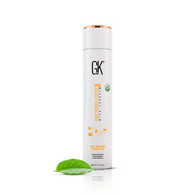 GK Hair Balancing Shampoo 300 ml white bottle with a rose gold cap and vegan badge, a green leaf at its base