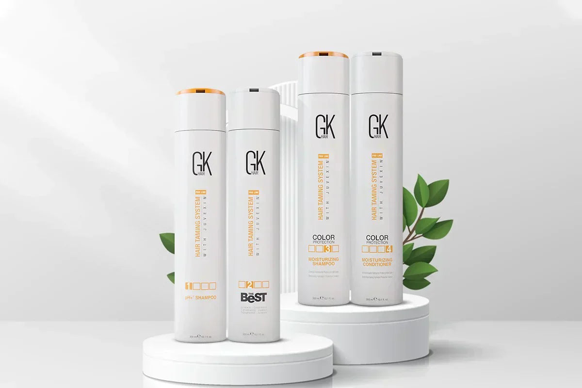 GK Hair's The Best Keratin Professional Hair Kit displayed on white podiums, including pH+ Shampoo, The Best Keratin Treatment, Moisturizing Shampoo, and Moisturizing Conditioner
