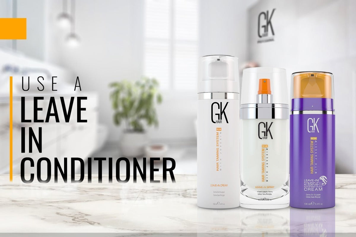 Stylish ad featuring three GK Hair leave-in conditioners on a marble counter. Text reads "Use a Leave In Conditioner." Bright, airy bathroom setting.