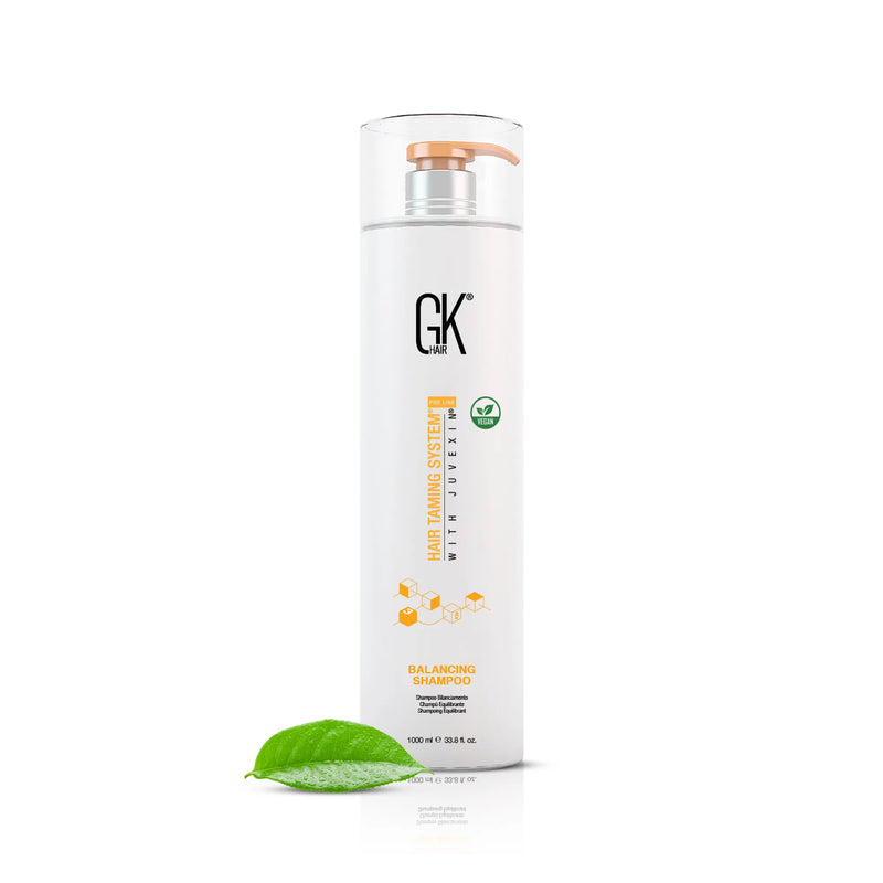 GK Hair Balancing Shampoo 1000 ml white bottle with a copper pump and vegan badge, a green leaf at its base
