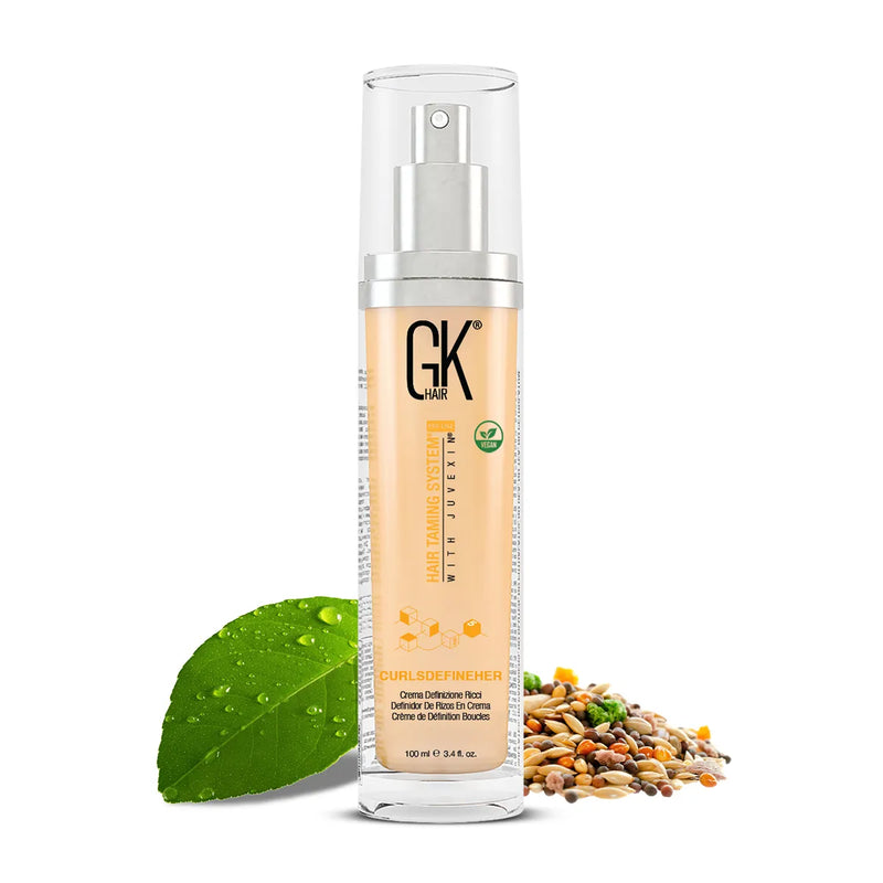GK Hair CurlsDefineHer curl definition cream 100 ml pump bottle, vegan badge, a dewy green leaf and mixed seeds at its base