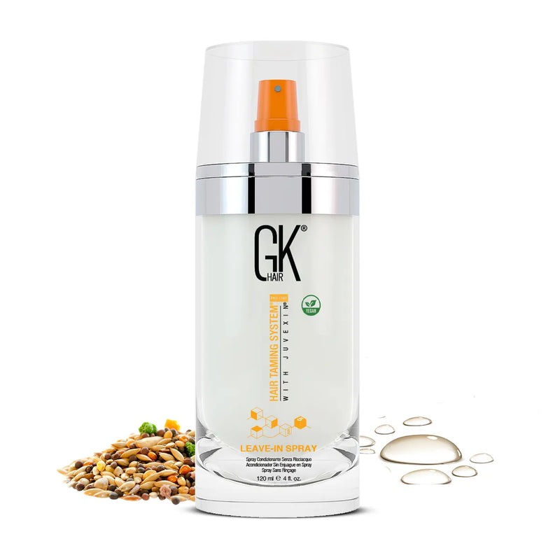 GK Hair Leave-In Spray, 120 ml 4 fl oz clear pump bottle marked vegan, beside a pile of mixed seeds and golden oil droplets