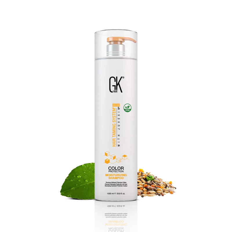 GK Hair Moisturizing Shampoo 1000 ml white bottle with a peach pump, front view, beside a wet green leaf and mixed grains