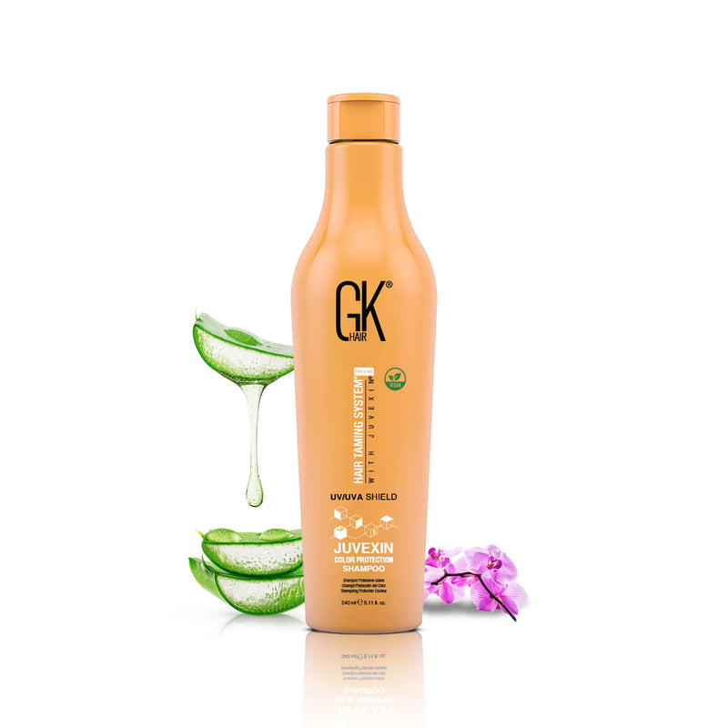 GK Hair Shield Shampoo 240 ml orange bottle labeled Juvexin Color Protection Shampoo, with aloe vera slices and a pink orchid