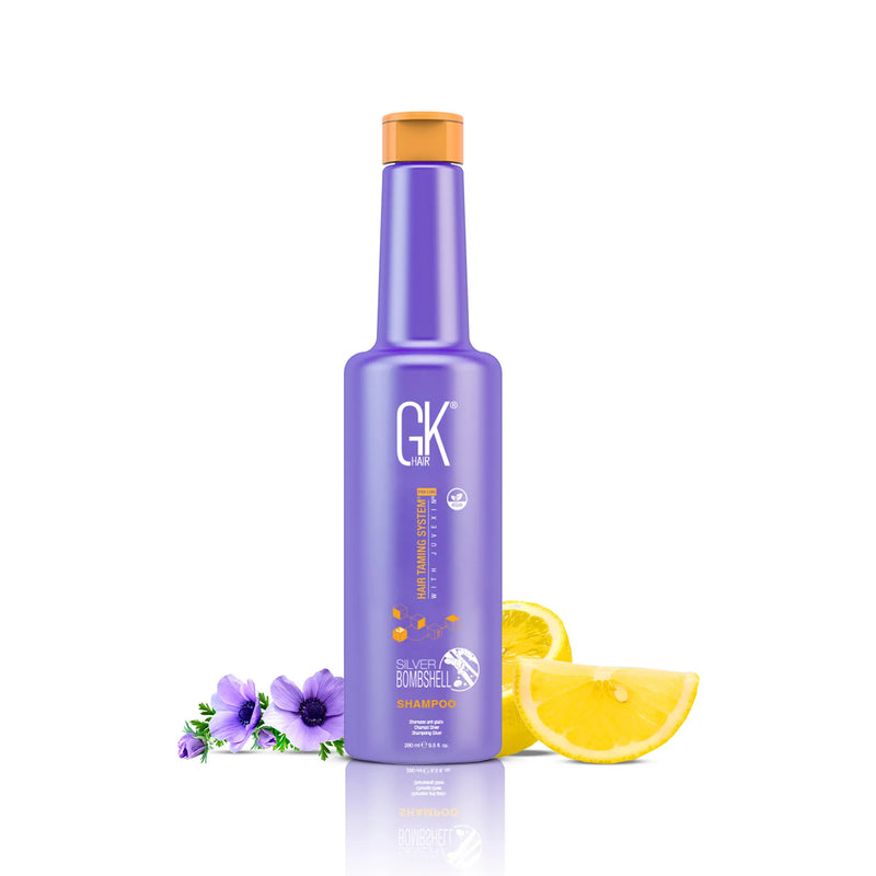 GK Hair Silver Bombshell Shampoo 280 ml purple bottle with an orange cap, beside purple anemones and lemon slices